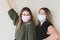 TwoÂ young women wearing face masks
